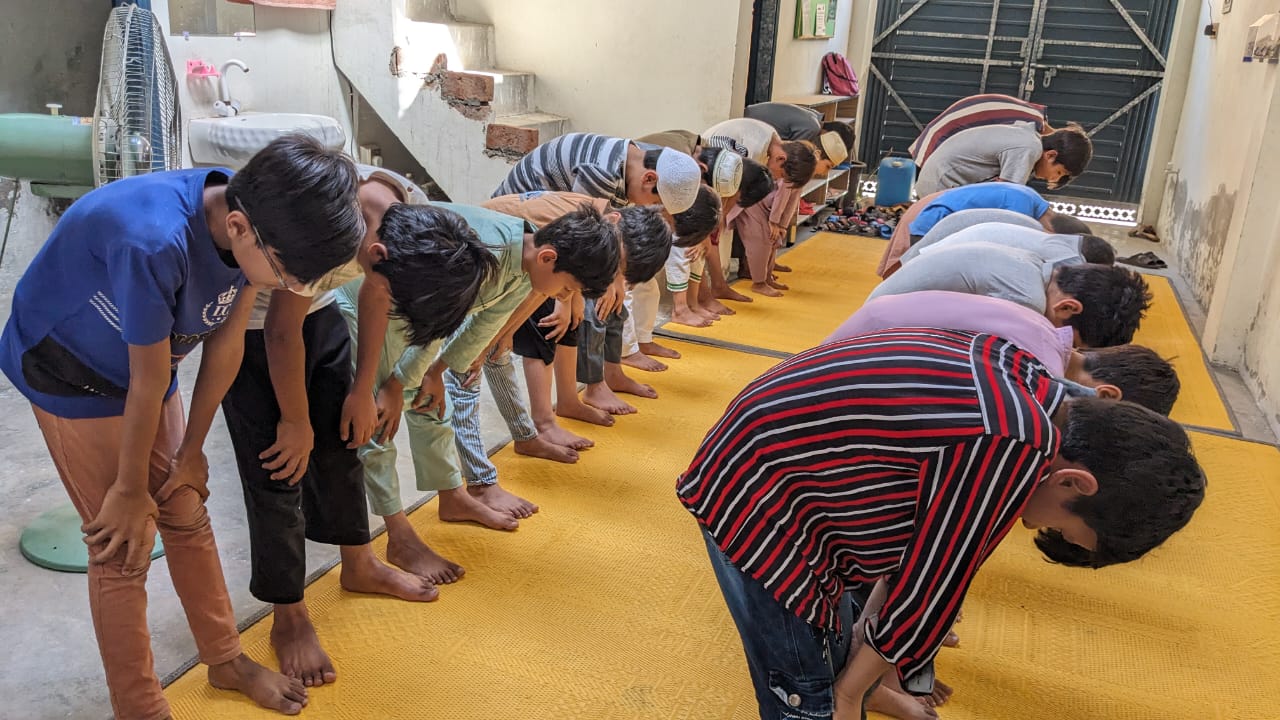 Students performing prayer in learning session